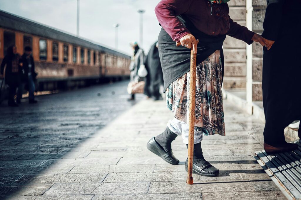 Old lady walking with cane