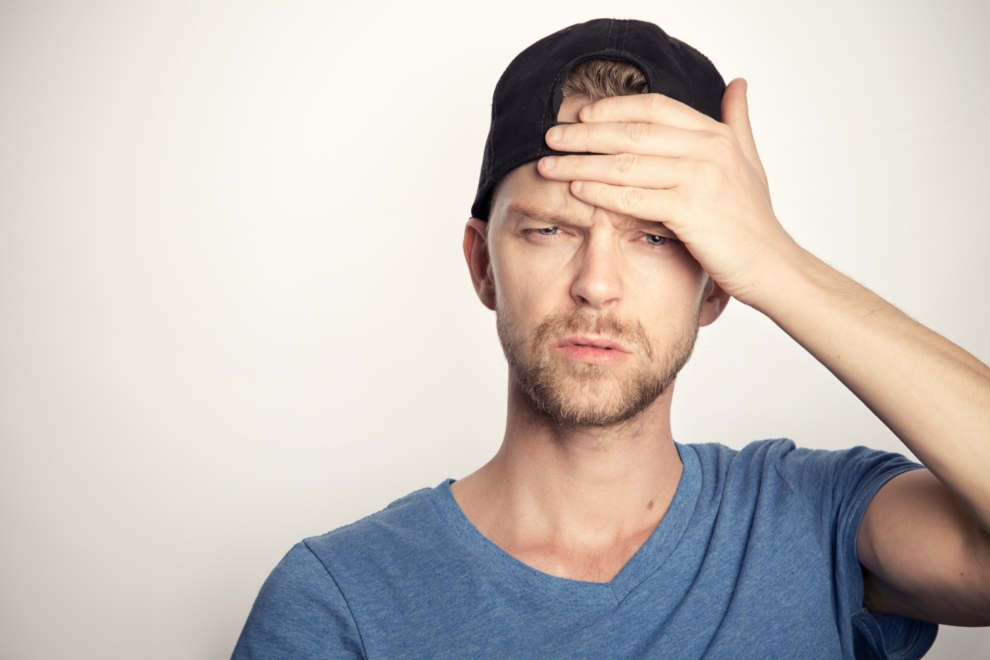 Man covering his face