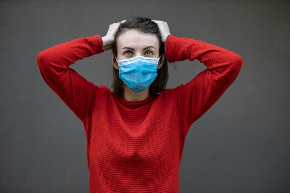 Woman in red sweater with face mask